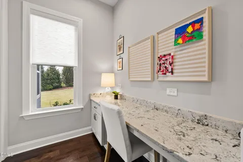 a view of an empty room with chandelier fan