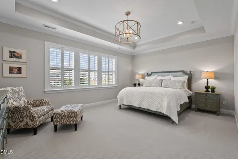 a living room with furniture and large windows