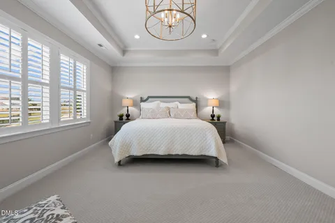 a spacious bedroom with a large bed and a large window