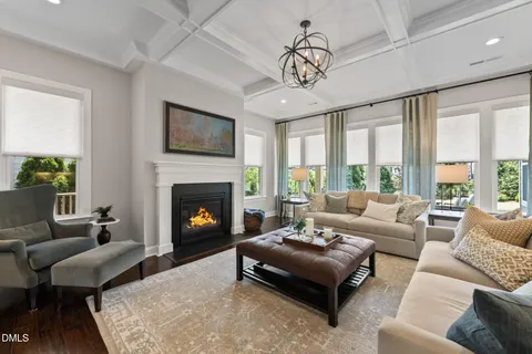 a living room with furniture fireplace and window