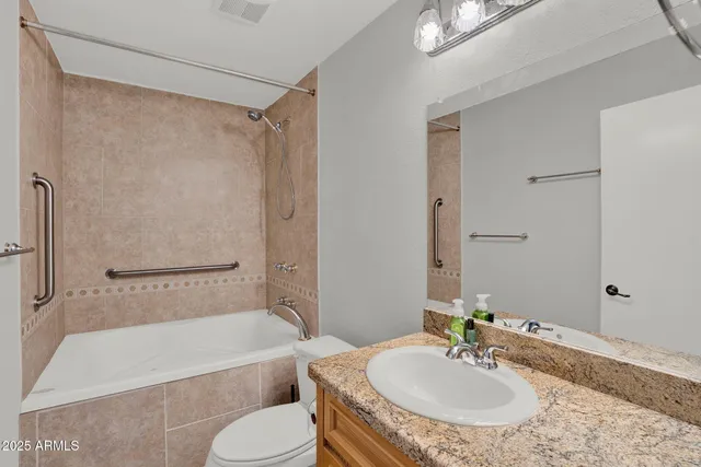 a bedroom with a large bed and a ceiling fan