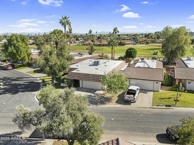 a view of a swimming pool with a patio and a yard