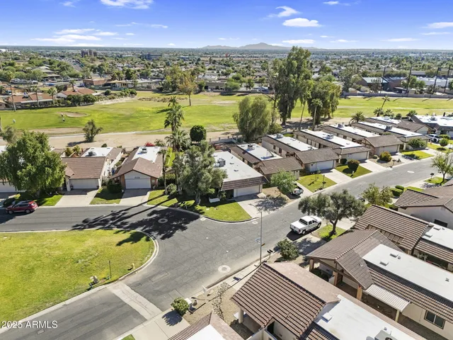 a view of a swimming pool with a patio and a yard