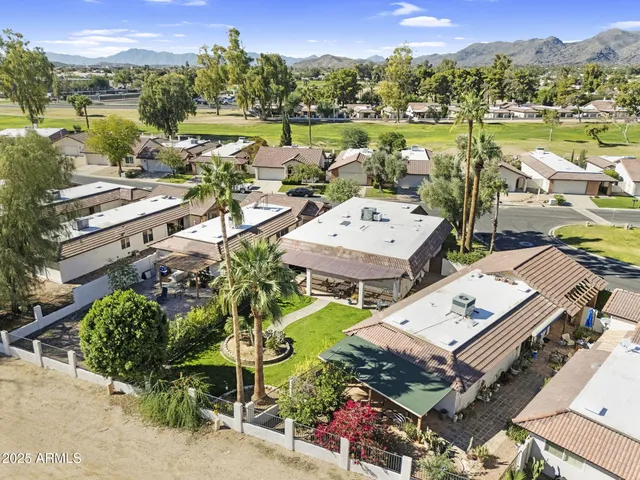 a view of a house with a yard and sitting area