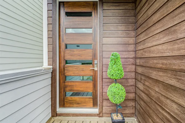 a view of a hallway with wooden floor and entryway