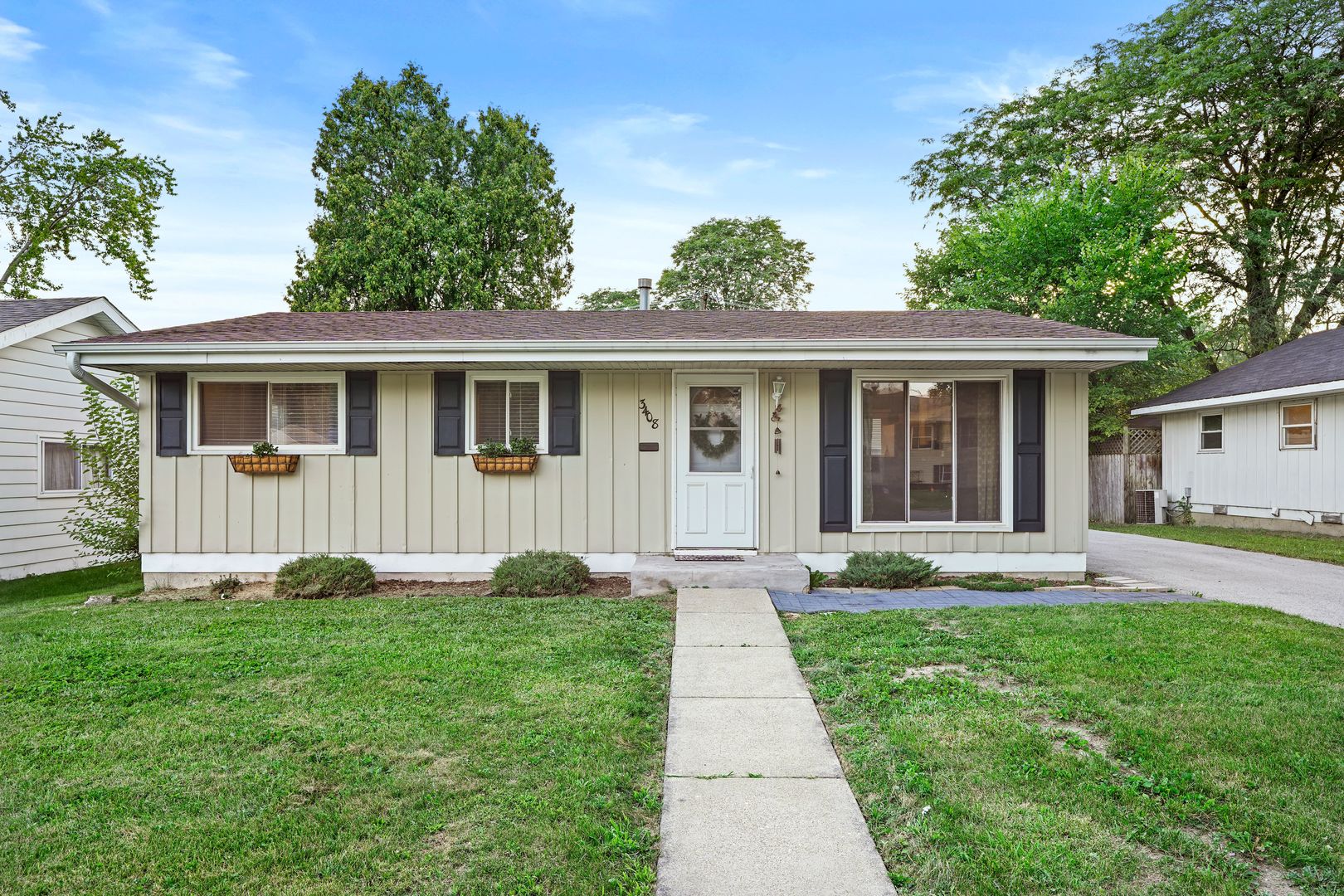 a front view of a house with a yard and porch