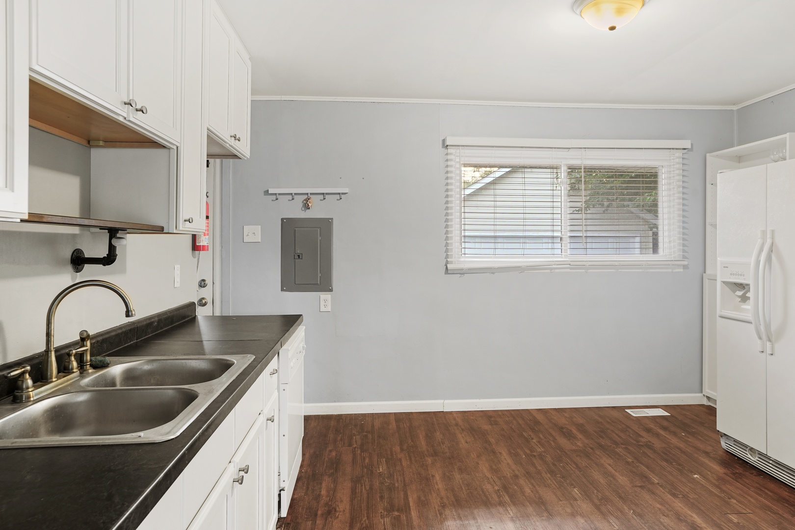 3408 Sally Drive Steger, IL 60475 - Photo 6 of 15 a kitchen with kitchen island granite countertop a sink a stove and wooden floor