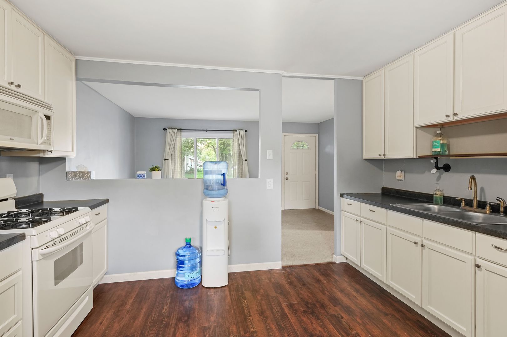 3408 Sally Drive Steger, IL 60475 - Photo 7 of 15 a kitchen with granite countertop a sink cabinets and wooden floor