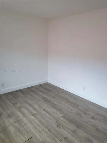 a white bath tub sitting next to a toilet