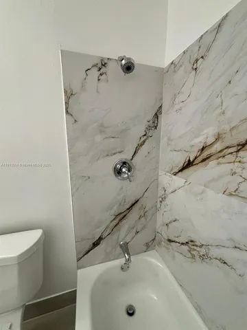 a bathroom with a toilet a sink and vanity
