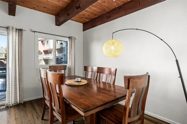 a view of a dining room with furniture wooden floor and chandelier