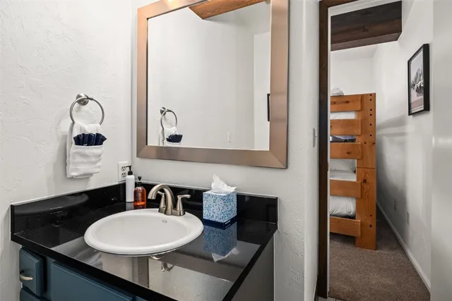 a bathroom with a sink a toilet and a mirror