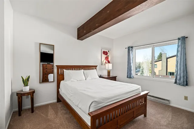 a bed sitting in a bedroom next to a window