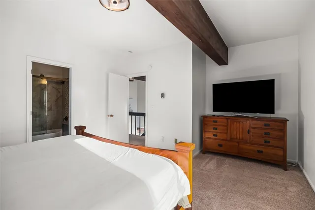 a bedroom with a bed and flat screen tv