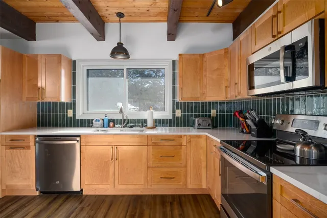a kitchen with stainless steel appliances granite countertop a stove and a sink