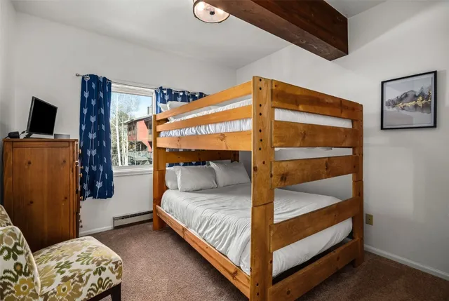 a living room with furniture a flat screen tv and a floor to ceiling window