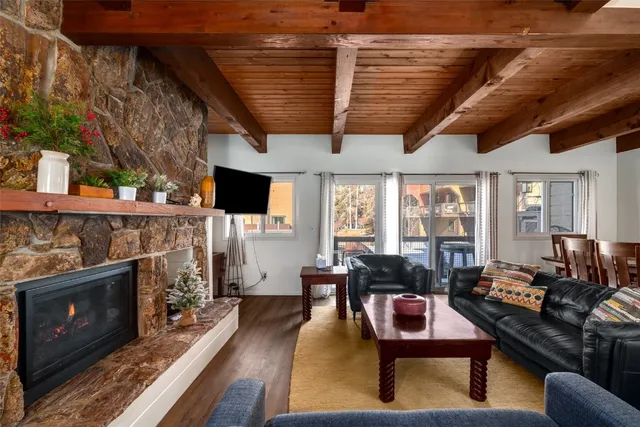 a living room with fireplace furniture and a flat screen tv