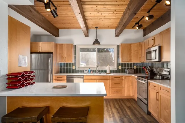 a kitchen with stainless steel appliances kitchen island granite countertop a sink and cabinets