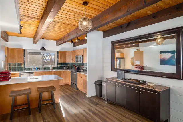 a kitchen with stainless steel appliances granite countertop a stove and a refrigerator