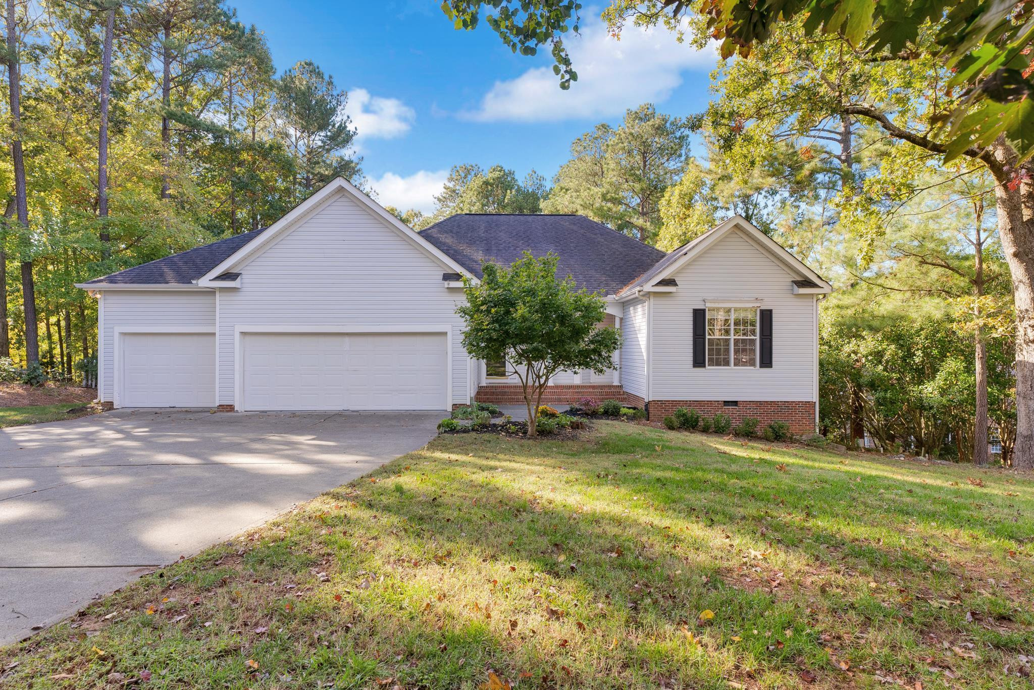 a view of a house with a yard and garage
