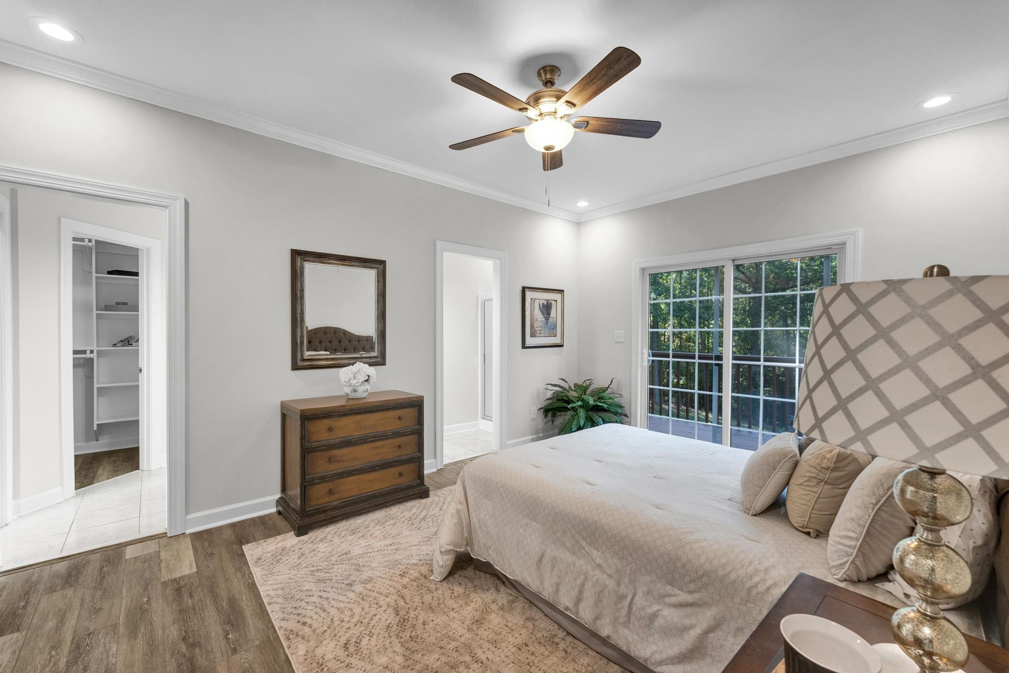 6914 Wexford Woods Trail Raleigh, NC 27613 - Photo 12 of 37 a bedroom with a large bed and a chandelier