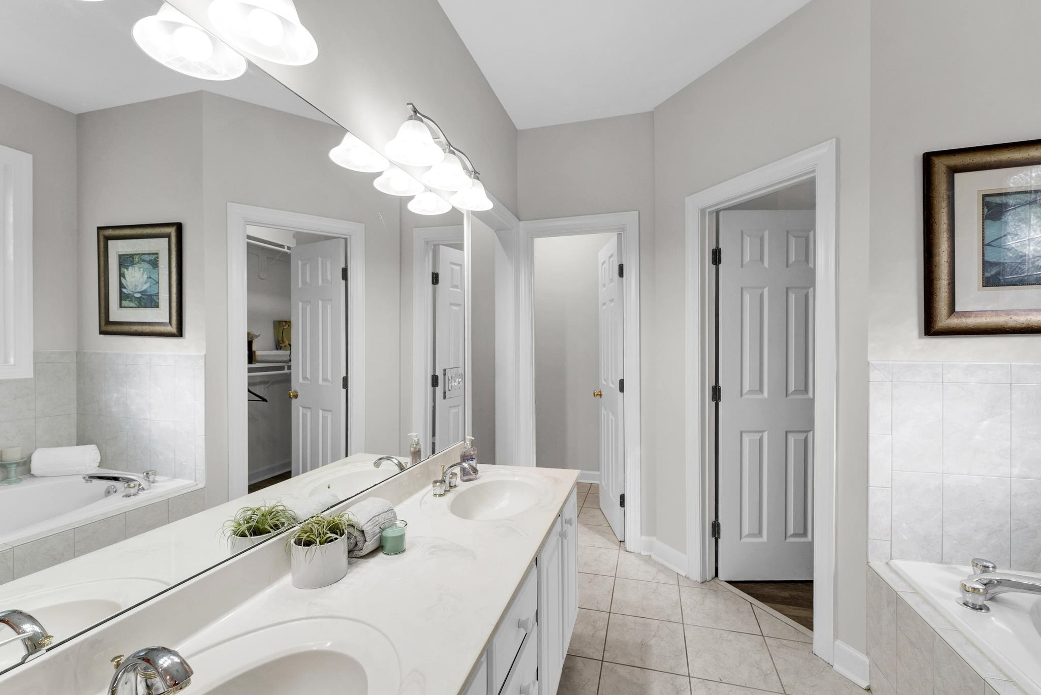 6914 Wexford Woods Trail Raleigh, NC 27613 - Photo 13 of 37 a bathroom with a sink tub shower and a mirror