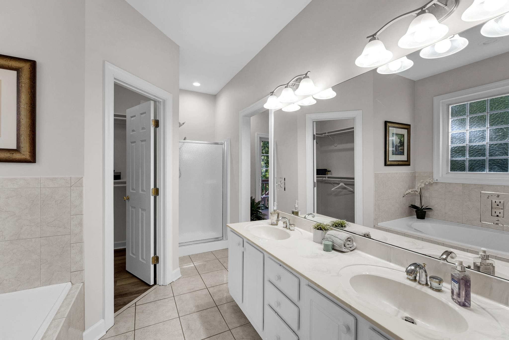 6914 Wexford Woods Trail Raleigh, NC 27613 - Photo 14 of 37 a bathroom with a double vanity sink mirror and shower