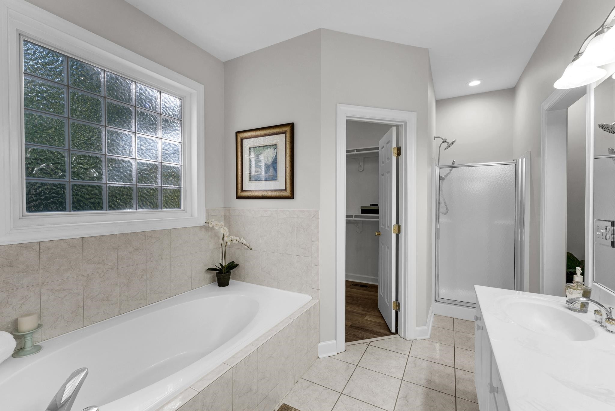 6914 Wexford Woods Trail Raleigh, NC 27613 - Photo 15 of 37 a bathroom with a tub a sink and a window