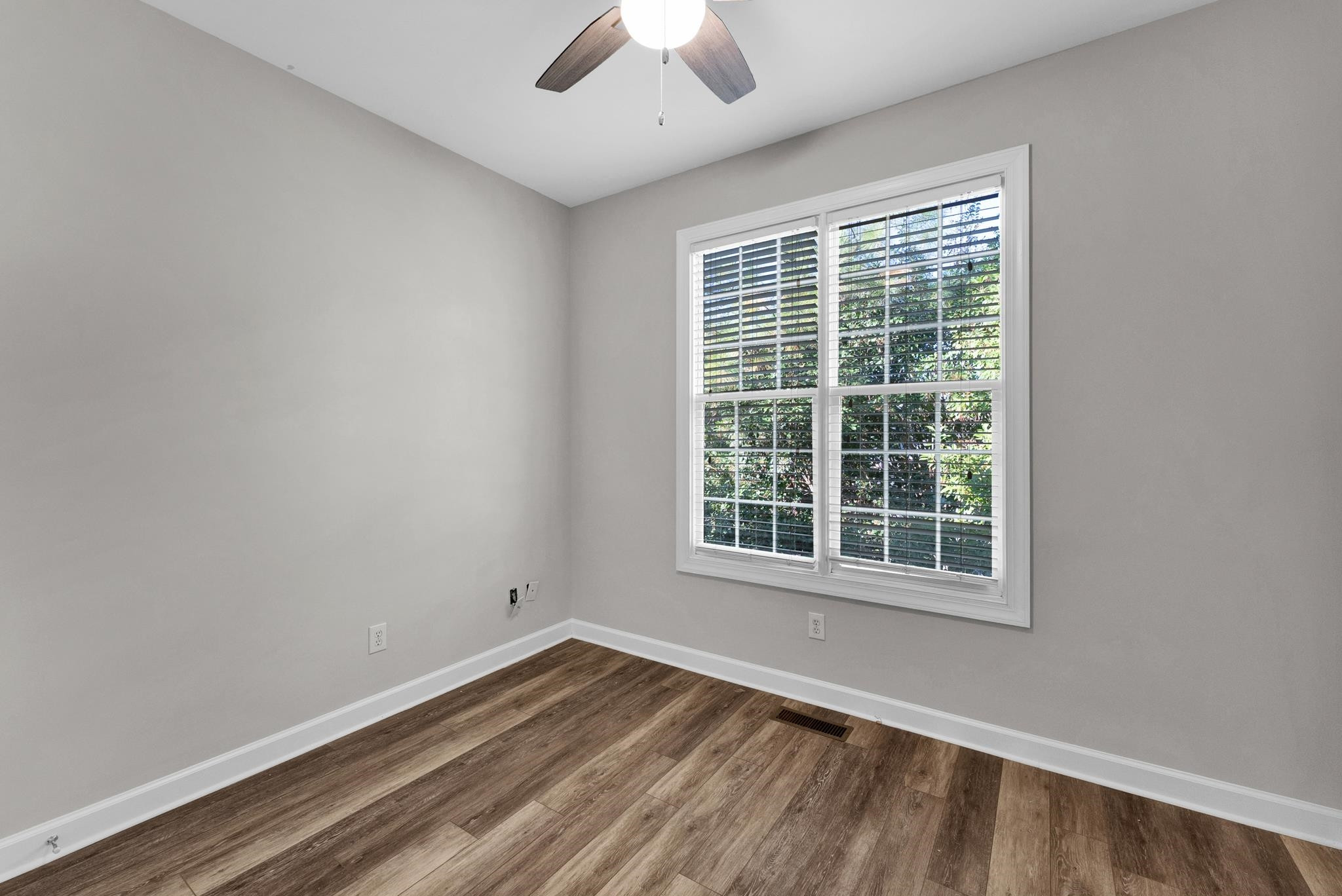 6914 Wexford Woods Trail Raleigh, NC 27613 - Photo 16 of 37 an empty room with wooden floor and windows