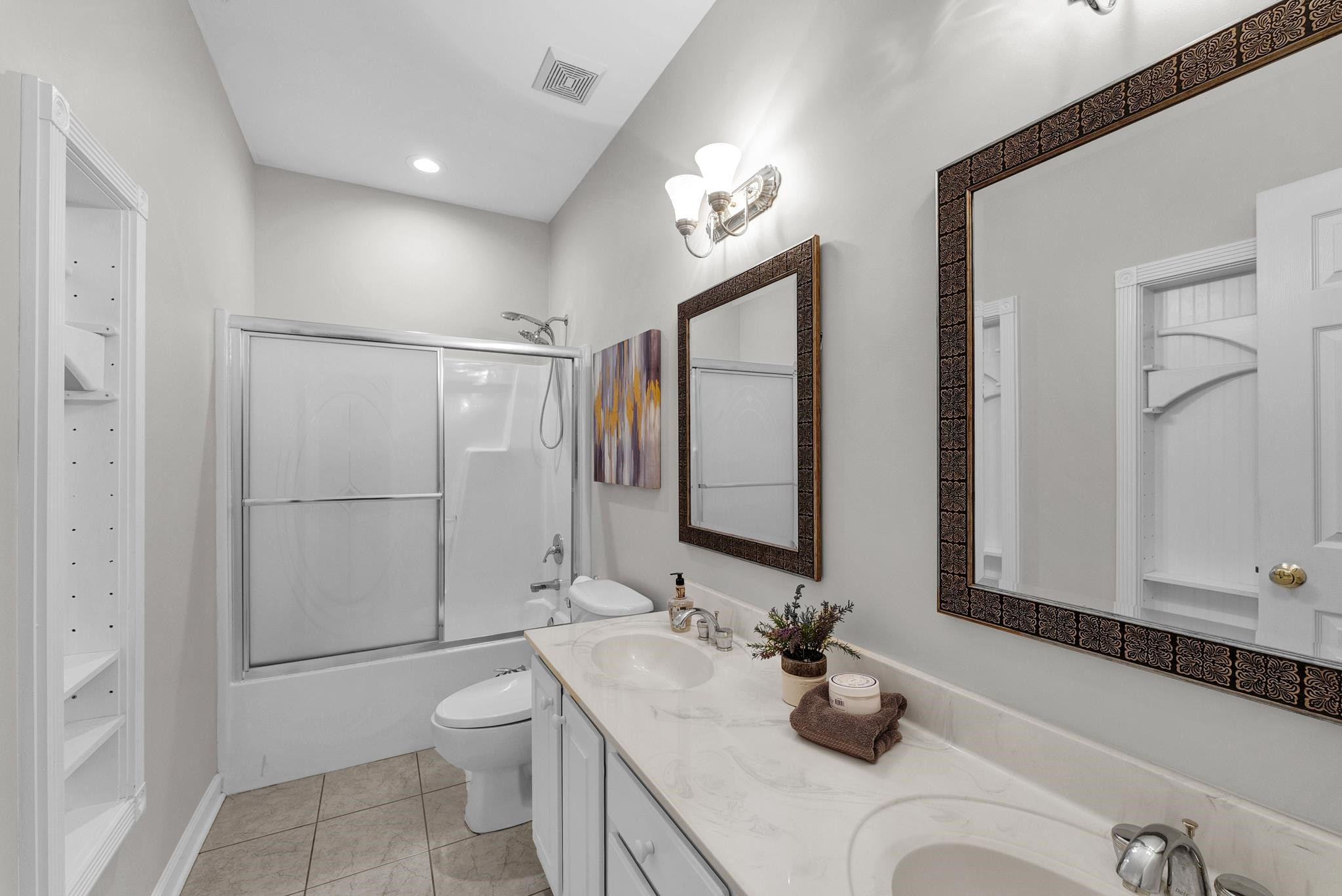 6914 Wexford Woods Trail Raleigh, NC 27613 - Photo 19 of 37 a bathroom with a granite countertop sink a toilet and mirror