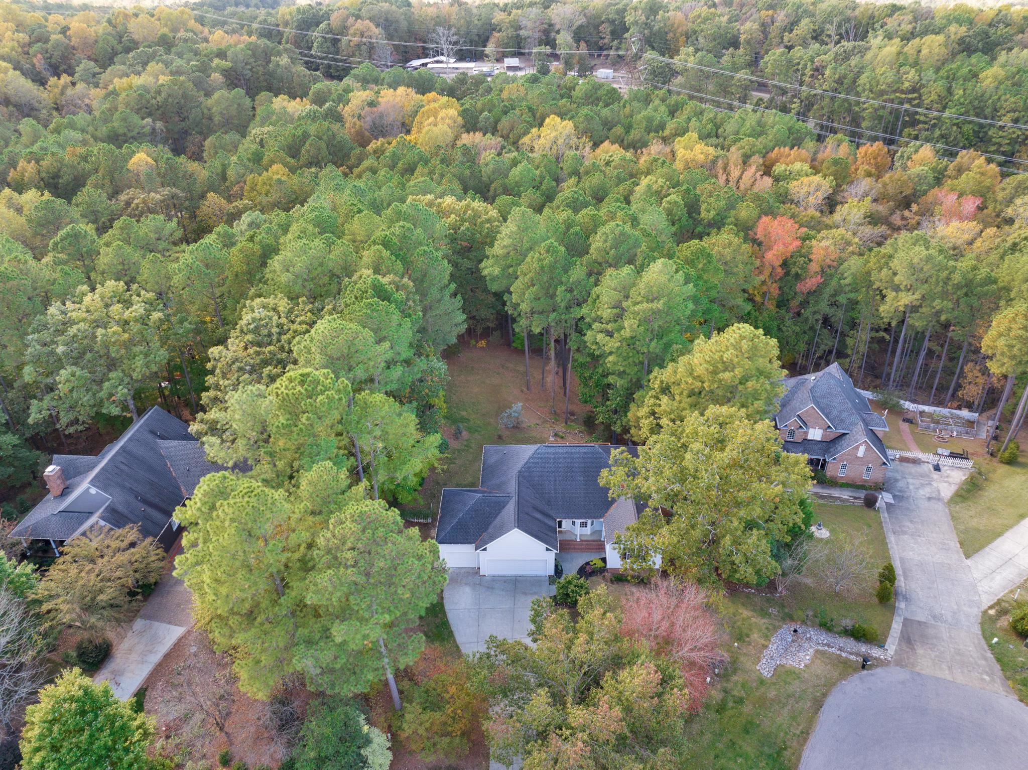 6914 Wexford Woods Trail Raleigh, NC 27613 - Photo 2 of 37 an aerial view of a house with yard and outdoor seating