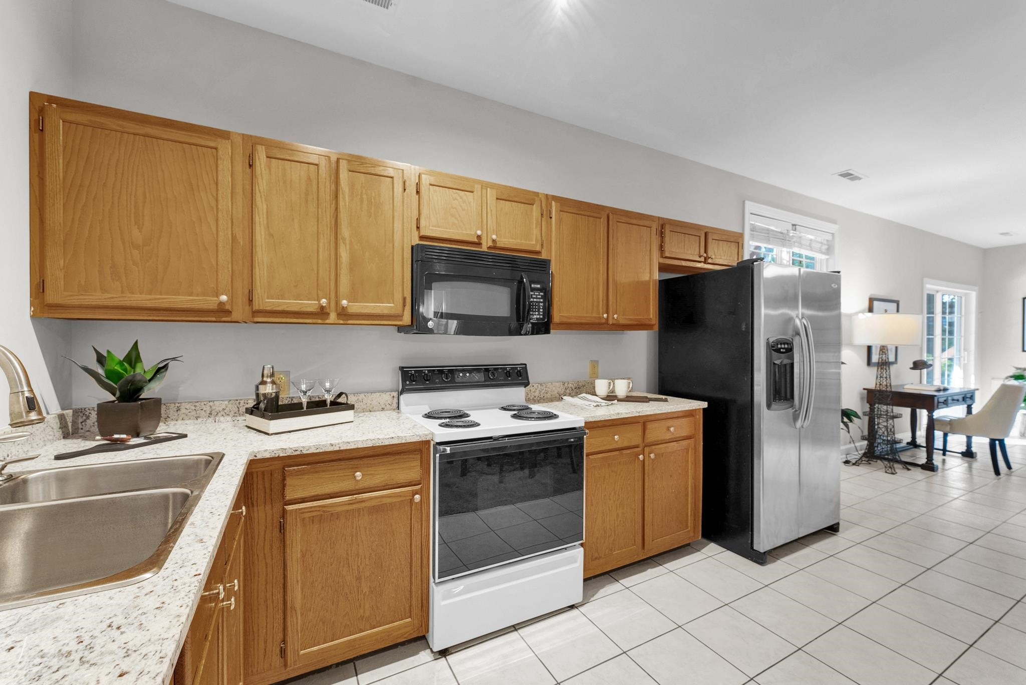 6914 Wexford Woods Trail Raleigh, NC 27613 - Photo 23 of 37 a kitchen with a sink a stove and refrigerator
