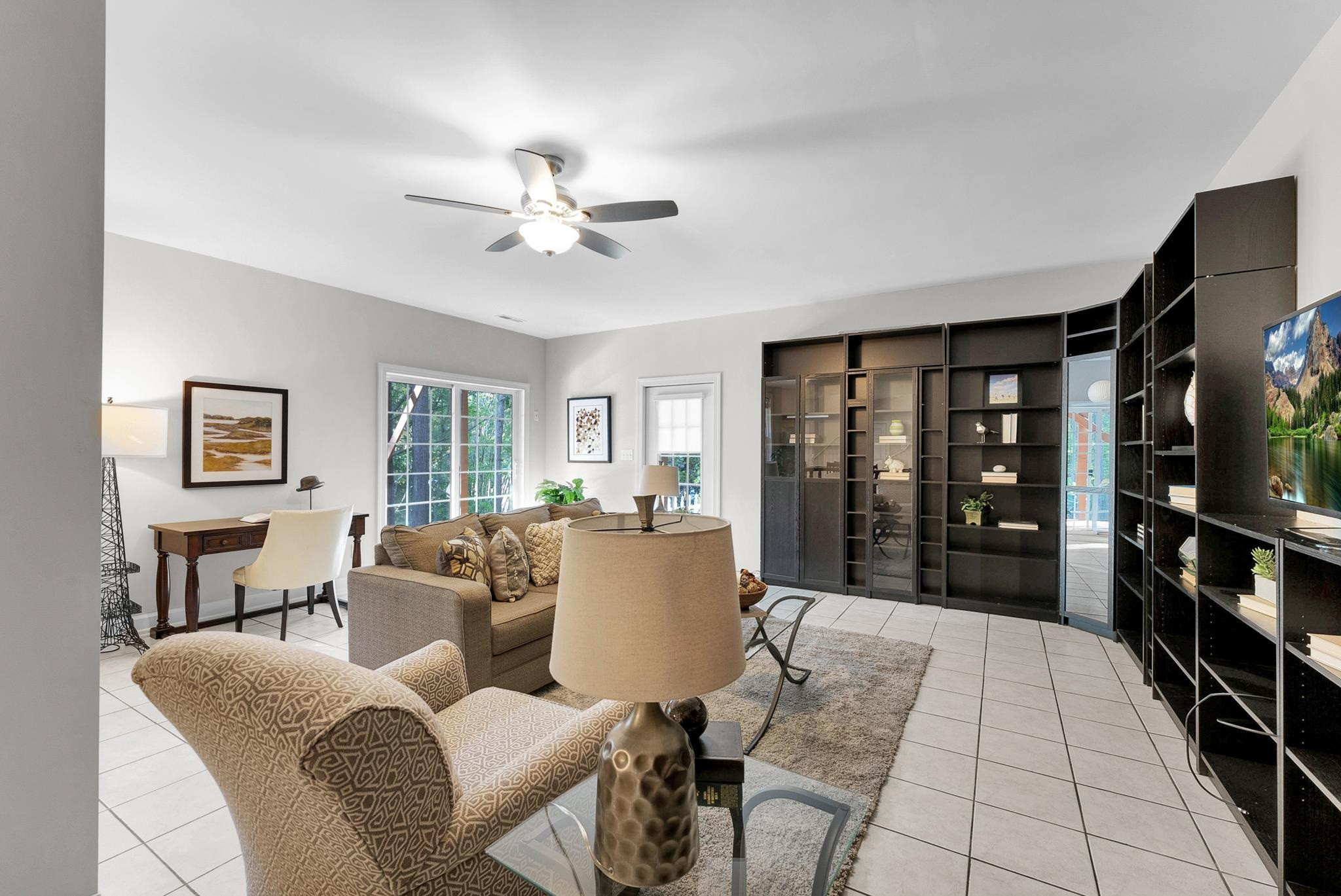6914 Wexford Woods Trail Raleigh, NC 27613 - Photo 27 of 37 a living room with furniture a window and a flat screen tv