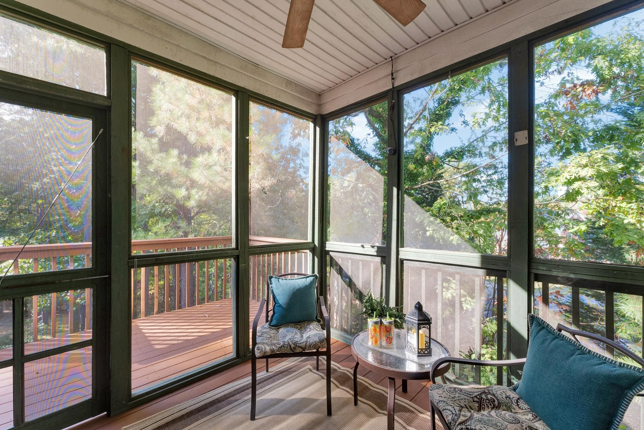 6914 Wexford Woods Trail Raleigh, NC 27613 - Photo 30 of 37 a living room with furniture and floor to ceiling windows