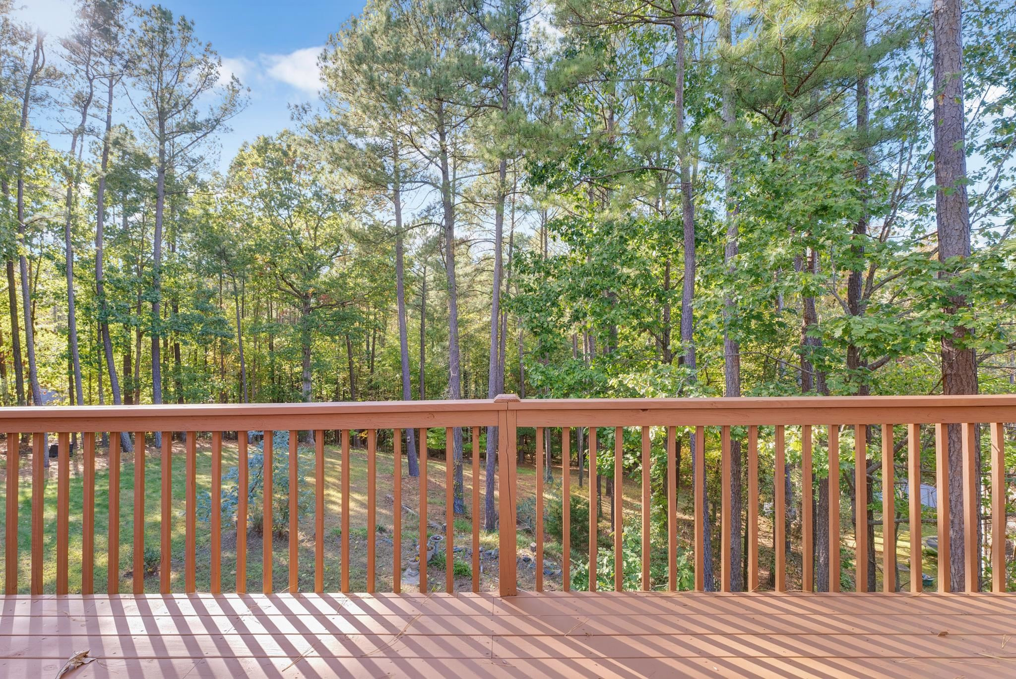 6914 Wexford Woods Trail Raleigh, NC 27613 - Photo 33 of 37 a wooden deck with trees in the background