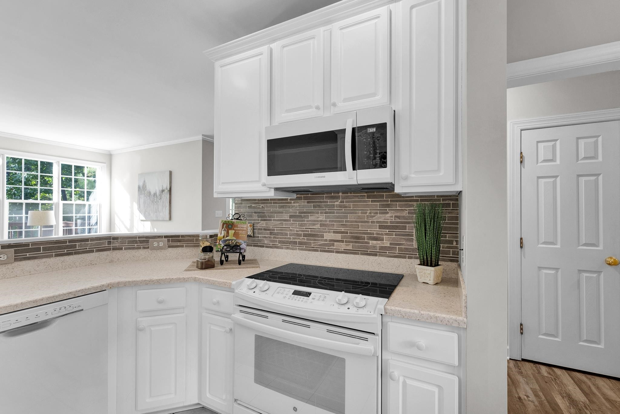 6914 Wexford Woods Trail Raleigh, NC 27613 - Photo 5 of 37 a kitchen with white cabinets and white appliances