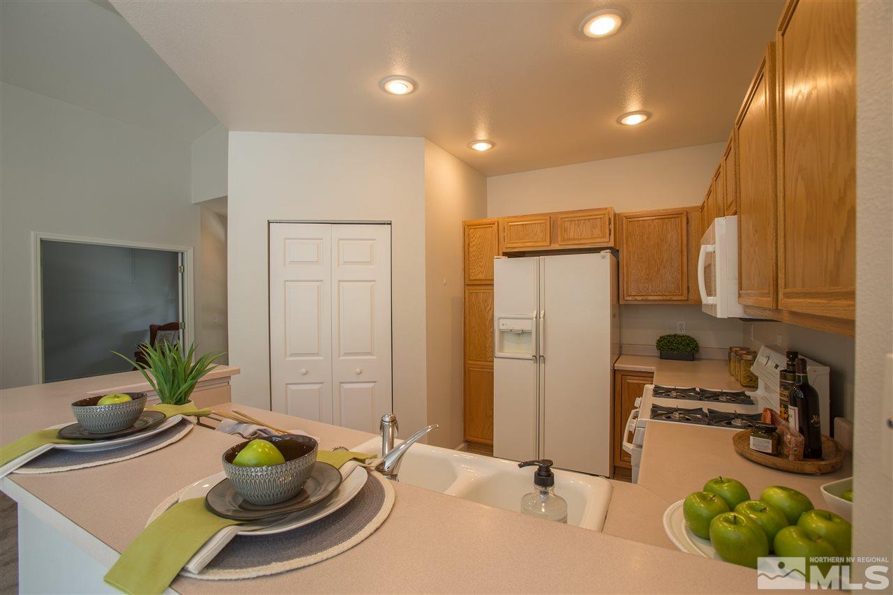 669 Caughlin Glen Reno, NV 89519 - Photo 10 of 25 a view of a dining room with furniture and a chandelier