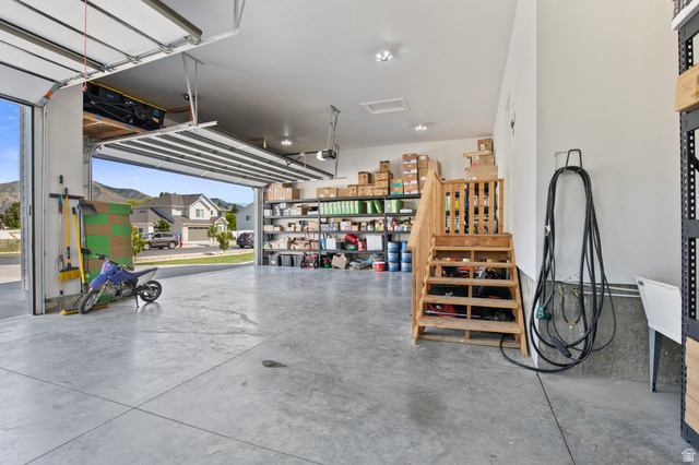 3111 South 1250 West Logan, UT 84321 - Photo 38 of 51 Spacious garage featuring a concrete floor, overhead lighting, and an open garage door