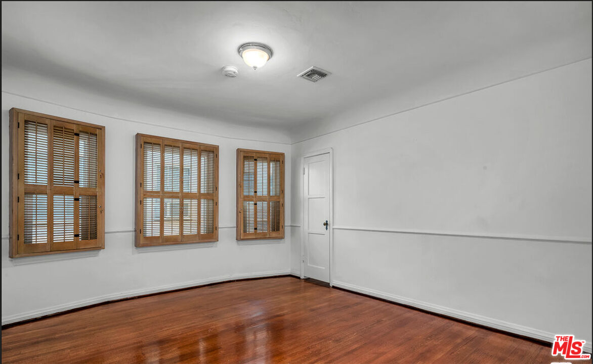 6369 Orange Street Los Angeles, CA 90048 - Photo 11 of 23 a view of an empty room with a window and wooden floor