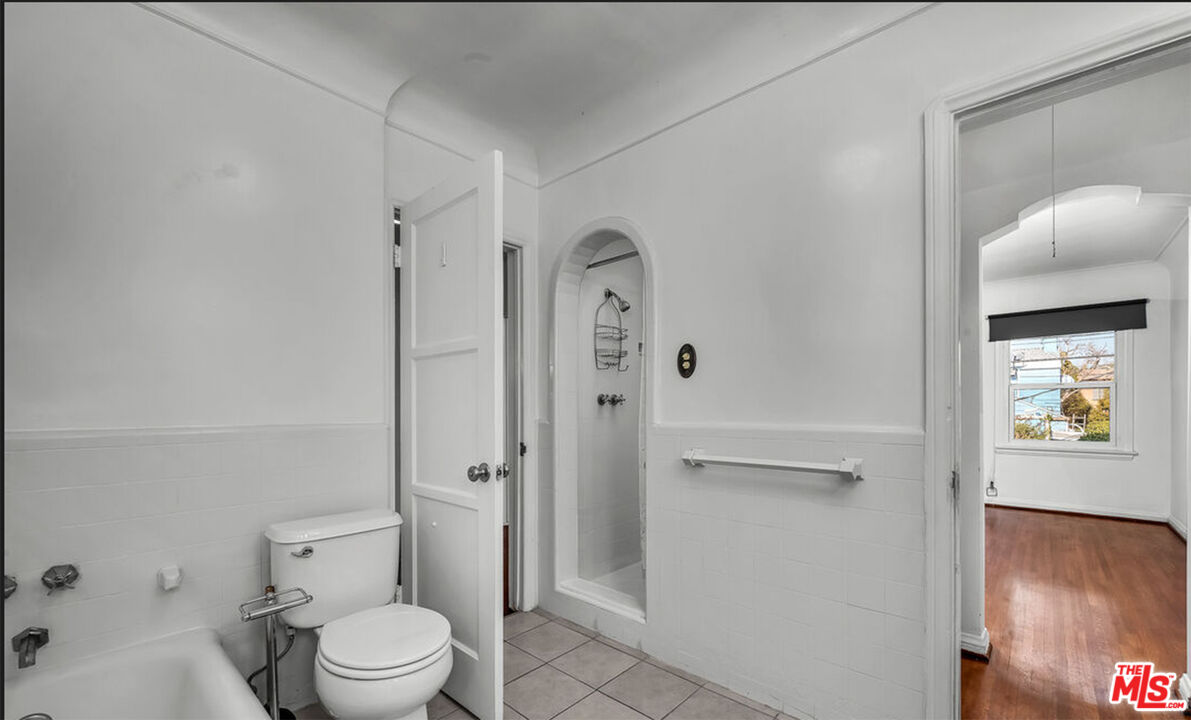 6369 Orange Street Los Angeles, CA 90048 - Photo 15 of 23 a bathroom with a toilet and a shower