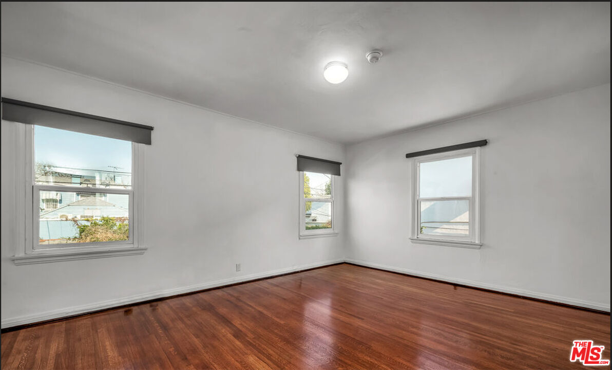 6369 Orange Street Los Angeles, CA 90048 - Photo 16 of 23 an empty room with wooden floor and windows