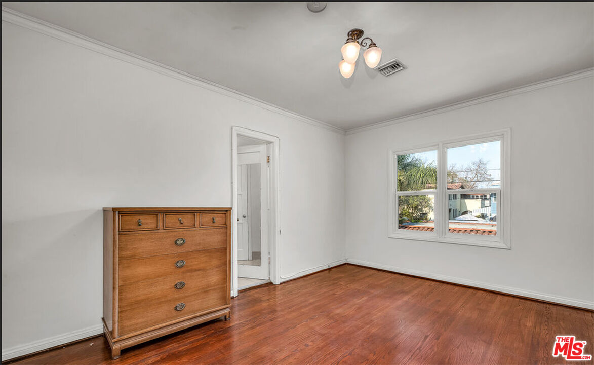 6369 Orange Street Los Angeles, CA 90048 - Photo 17 of 23 wooden floor in an empty room with a window