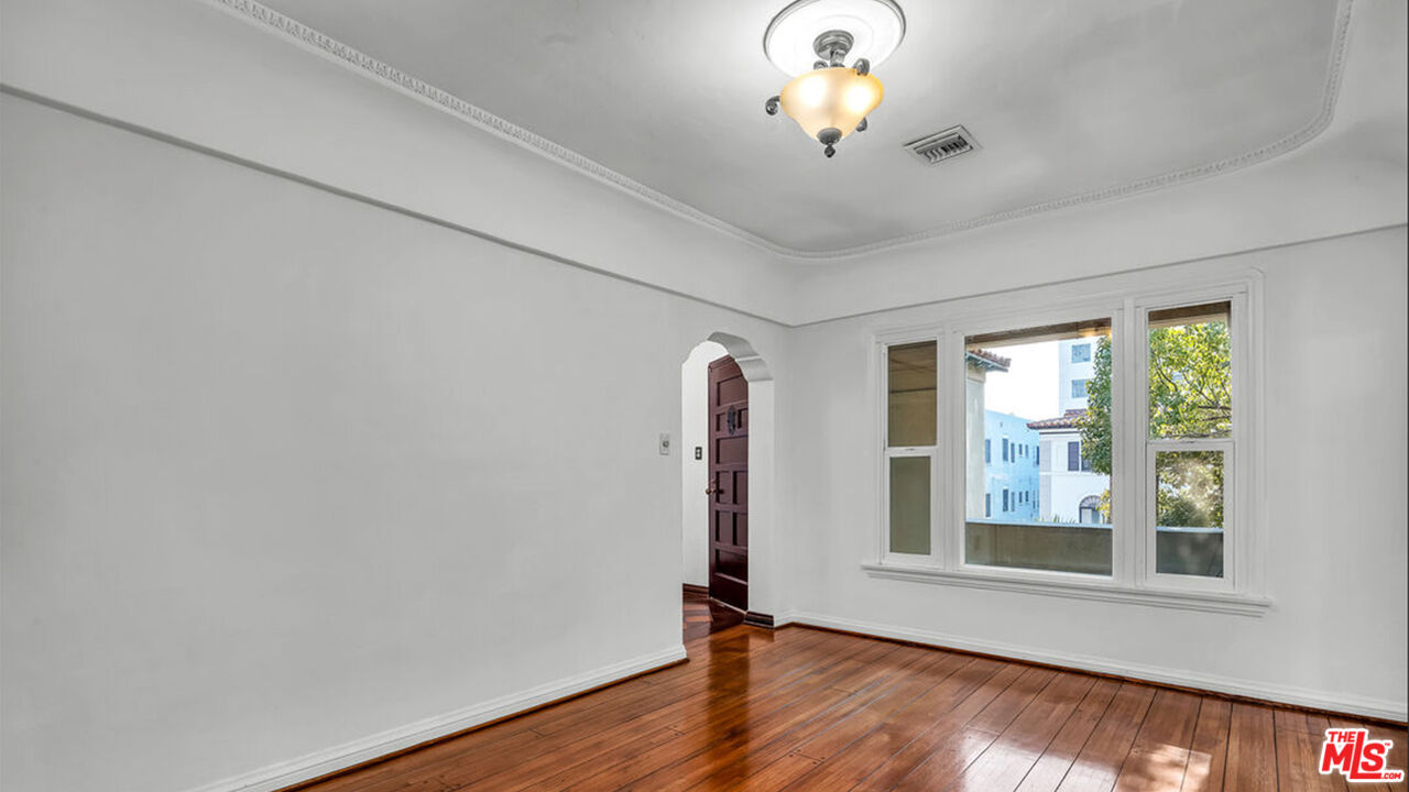6369 Orange Street Los Angeles, CA 90048 - Photo 19 of 23 a view of an empty room with window and wooden floor