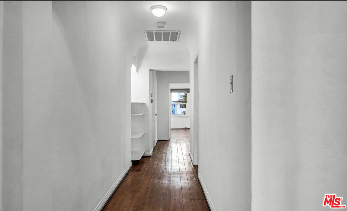 6369 Orange Street Los Angeles, CA 90048 - Photo 22 of 23 a view of a hallway with wooden floor