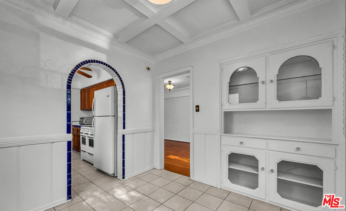 6369 Orange Street Los Angeles, CA 90048 - Photo 8 of 23 a kitchen with stainless steel appliances granite countertop a refrigerator and a stove top oven