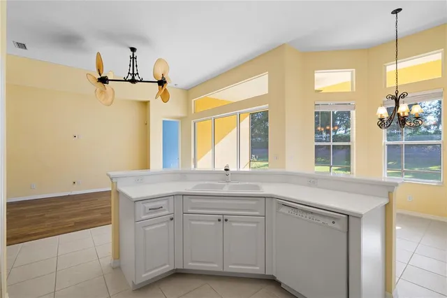 a view of a room with wooden floor and windows