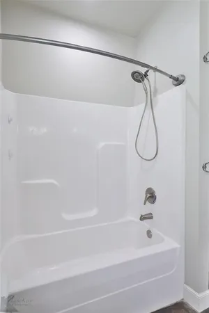 a bathroom with a bath tub with a shower