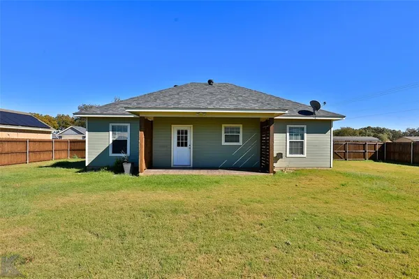 a front view of a house with yard and porch