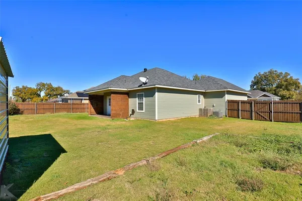a front view of a house with a big yard