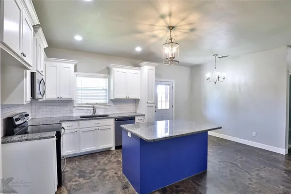 a spacious bathroom with a granite countertop sink a mirror and a vanity